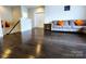 Open living room featuring hardwood floors, neutral paint, and a staircase at 413 Hunton Forest Dr, Concord, NC 28027