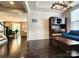Spacious living room featuring hardwood floors, an elegant chandelier, and ample natural light, ideal for comfortable living at 413 Hunton Forest Dr, Concord, NC 28027