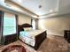 Spacious main bedroom featuring tray ceilings, recessed lighting, and two windows at 413 Hunton Forest Dr, Concord, NC 28027