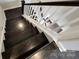 Elegant staircase featuring hardwood steps and white railings, connecting the different levels of the home with style at 413 Hunton Forest Dr, Concord, NC 28027