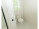 Clean bathroom with white toilet and marble tile flooring with a window providing natural light at 4410 Laurel Twig Ct, Charlotte, NC 28215