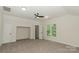 Large bedroom with ceiling fan, neutral carpet, and large window at 4410 Laurel Twig Ct, Charlotte, NC 28215