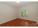 Cozy bedroom featuring hardwood floors and a bright window at 4410 Laurel Twig Ct, Charlotte, NC 28215