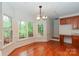 Sunny breakfast area with hardwood floors, large windows overlooking backyard, and built-in desk at 4410 Laurel Twig Ct, Charlotte, NC 28215
