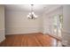 Elegant dining room featuring hardwood floors, wainscoting, crown molding, and a decorative chandelier at 4410 Laurel Twig Ct, Charlotte, NC 28215
