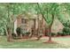 Charming two-story brick home featuring a landscaped front yard, mature trees and shuttered windows at 4410 Laurel Twig Ct, Charlotte, NC 28215