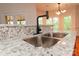 Granite counters highlight the stainless steel sink and modern faucet at 4410 Laurel Twig Ct, Charlotte, NC 28215