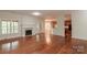 Spacious living room with fireplace and rich hardwood floors at 4410 Laurel Twig Ct, Charlotte, NC 28215