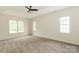 Main bedroom with tray ceilings, neutral walls, carpet floor, and natural light at 4410 Laurel Twig Ct, Charlotte, NC 28215