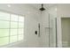 A modern glass-enclosed shower with black fixtures and white marble tile at 4410 Laurel Twig Ct, Charlotte, NC 28215