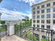 Balcony overlooks a street, providing a serene view of office buildings on a partly cloudy day at 4625 Piedmont Row Dr # 701, Charlotte, NC 28210