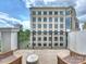 Relaxing balcony view with seating overlooking corporate towers in the distance at 4625 Piedmont Row Dr # 701, Charlotte, NC 28210