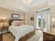 Comfortable bedroom featuring a queen bed, soft carpet and balcony access at 4625 Piedmont Row Dr # 701, Charlotte, NC 28210