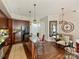 Modern kitchen with stainless steel appliances, granite countertops, an island with seating and a cozy dining area with wood accents at 4625 Piedmont Row Dr # 701, Charlotte, NC 28210
