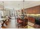 Stylish kitchen open to the living area with dark wood cabinets, stainless steel appliances, and a center island with bar stool seating at 4625 Piedmont Row Dr # 701, Charlotte, NC 28210