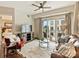 Inviting living room featuring a ceiling fan, balcony access, and comfortable seating arrangements at 4625 Piedmont Row Dr # 701, Charlotte, NC 28210