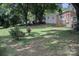 Spacious backyard with lots of shade trees behind the house at 515 Upper Spencer Mountain Rd, Stanley, NC 28164