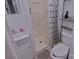 Bathroom features white vanity, shower with curtain, and toilet at 515 Upper Spencer Mountain Rd, Stanley, NC 28164