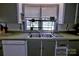 Close up on a bright kitchen with ample counter space and a double basin sink at 515 Upper Spencer Mountain Rd, Stanley, NC 28164