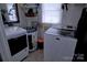 A functional laundry room space with machines and shelving at 515 Upper Spencer Mountain Rd, Stanley, NC 28164