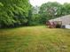 An expansive, private backyard provides ample space, a deck, and mature trees at 544 Bentley Rd, Shelby, NC 28152