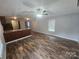 Open floor plan featuring wood flooring, ceiling fan, and view into the kitchen at 544 Bentley Rd, Shelby, NC 28152