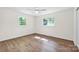 Empty bedroom featuring plank floors, a ceiling fan, and large windows at 612 Summerow Rd # Lot 22, Stanley, NC 28164