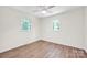 Bright bedroom with plank flooring, ceiling fan, and two windows at 612 Summerow Rd # Lot 22, Stanley, NC 28164