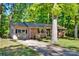 Charming brick home with a metal roof, a well-manicured lawn, and mature trees offering shade and curb appeal at 612 Summerow Rd # Lot 22, Stanley, NC 28164