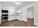 Bright and modern kitchen with white cabinets, updated appliances, subway tile backsplash, and modern laminate flooring at 612 Summerow Rd # Lot 22, Stanley, NC 28164