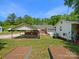 Spacious backyard with garden beds, carport, and outbuilding, perfect for outdoor living at 613 W Pine St, Kershaw, SC 29067