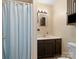 Cozy bathroom with walk-in shower and dark wood vanity at 613 W Pine St, Kershaw, SC 29067