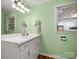 Bright bathroom features white vanity, a mirror, and a window, providing a clean and functional space at 613 W Pine St, Kershaw, SC 29067