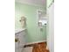 Charming bathroom features a single vanity, wood floors, and a window providing natural light and ventilation at 613 W Pine St, Kershaw, SC 29067