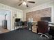 Bedroom that could be used as an office, with brick and ceiling fan at 613 W Pine St, Kershaw, SC 29067