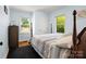 Bright bedroom boasts natural light, hardwood floors, and two windows offering a cozy and inviting space at 613 W Pine St, Kershaw, SC 29067