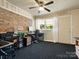 Bedroom that could be used as an office, with brick and ceiling fan at 613 W Pine St, Kershaw, SC 29067