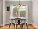 Dining area featuring hardwood floors, a chandelier, metal chairs, and a window at 613 W Pine St, Kershaw, SC 29067