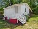 View of the side of the home and the surrounding yard at 613 W Pine St, Kershaw, SC 29067