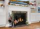 Beautiful fireplace with tile surround, decorative mantle, and built-in shelving offers a cozy ambiance at 613 W Pine St, Kershaw, SC 29067