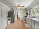Bright kitchen with stainless steel refrigerator, hardwood floors, grey cabinets, and ample counter space at 613 W Pine St, Kershaw, SC 29067