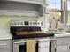 Stainless steel oven with wooden cutting board sits in a kitchen with hardwood floors at 613 W Pine St, Kershaw, SC 29067