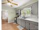 A full view of the kitchen featuring stainless steel appliances, wood floors, and a charming aesthetic at 613 W Pine St, Kershaw, SC 29067