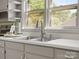 A close-up of the kitchen sink with stainless steel fixtures and a view of the outdoors at 613 W Pine St, Kershaw, SC 29067