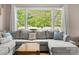 Cozy living room view highlighting natural light from the large windows and a comfortable sectional sofa at 613 W Pine St, Kershaw, SC 29067