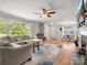 Spacious living room with hardwood floors, a ceiling fan, a fireplace and a comfortable seating area at 613 W Pine St, Kershaw, SC 29067