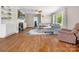 Inviting living room features a cozy fireplace, built-in shelving, hardwood floors, and lots of natural light at 613 W Pine St, Kershaw, SC 29067