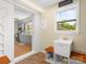 An open mudroom featuring a wash sink, shelving, and a glimpse of the adjacent kitchen area at 613 W Pine St, Kershaw, SC 29067