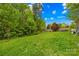 Expansive, well-maintained backyard surrounded by mature trees and landscaping at 619 Vega Nw St, Concord, NC 28027