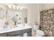 Bright bathroom featuring a double vanity, stylish mirror, and floral shower curtain at 619 Vega Nw St, Concord, NC 28027